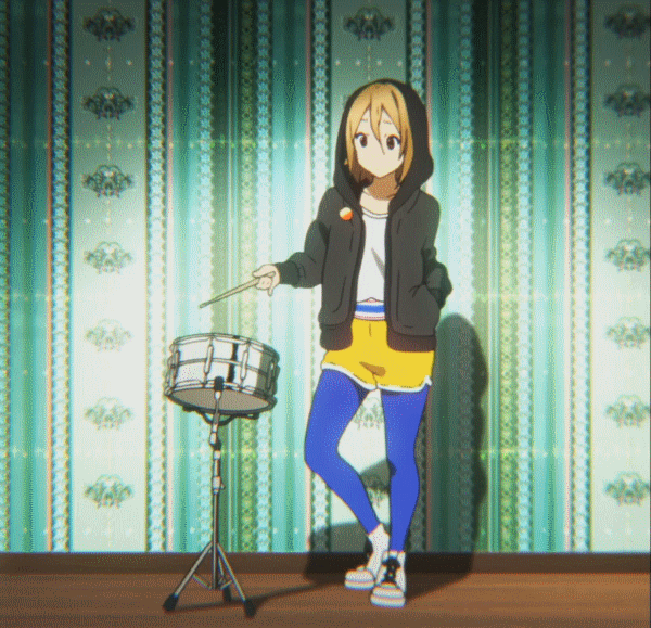 Ritsu banging drum while standing